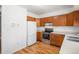 Kitchen with wood cabinets, stainless steel appliances, and light countertops at 7933 York St # 1, Denver, CO 80229