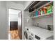 Convenient laundry room with washer, dryer, and storage at 7933 York St # 1, Denver, CO 80229