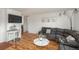 Living room with sectional sofa, console table, and hardwood floors at 7933 York St # 1, Denver, CO 80229