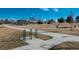 Pathway through Rotella park with benches and bike rack at 7933 York St # 1, Denver, CO 80229