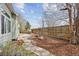 Backyard featuring stone landscaping, a wooden fence, and a well-manicured lawn at 14938 Clayton St, Thornton, CO 80602