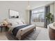 Relaxing bedroom featuring a large window, plush carpet, and tasteful decorations and lighting at 14938 Clayton St, Thornton, CO 80602
