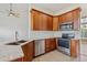 Well-equipped kitchen features stainless steel appliances, granite countertops, and warm-toned cabinetry at 14938 Clayton St, Thornton, CO 80602