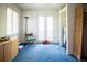 Another empty bedroom with blue carpet and door to balcony at 1257 Quitman St, Denver, CO 80204