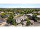 Aerial view of the condo complex near a lake and park with a skyline view in the distance at 5745 W Atlantic Pl # 108, Lakewood, CO 80227