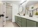 Updated bathroom featuring double sinks, new fixtures, and tiled shower-tub combo at 5745 W Atlantic Pl # 108, Lakewood, CO 80227