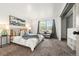 Bedroom features a comfy bed, side tables, and a window overlooking a tree lined street at 5745 W Atlantic Pl # 108, Lakewood, CO 80227