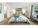 Cozy bedroom features a king bed, bedside lamps, and an ensuite bathroom at 5745 W Atlantic Pl # 108, Lakewood, CO 80227