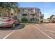 Apartment exterior with reserved parking spots, showing balconies and well-kept landscaping at 5745 W Atlantic Pl # 108, Lakewood, CO 80227