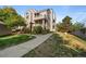 Multi-story townhouse with manicured landscaping at 5745 W Atlantic Pl # 108, Lakewood, CO 80227