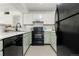 Well-lit kitchen featuring white countertops, black appliances, and practical design at 5745 W Atlantic Pl # 108, Lakewood, CO 80227