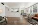 Open-concept living space with wood floors, connecting the kitchen and dining area at 5745 W Atlantic Pl # 108, Lakewood, CO 80227