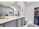 Bright bathroom featuring double sinks and a tiled shower with storage at 3010 W Prentice Ave # J, Littleton, CO 80123