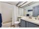 Cozy bathroom featuring a shower-tub combo with white tile surround and a light vanity at 3010 W Prentice Ave # J, Littleton, CO 80123