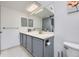 Bathroom with double sink vanity and gray cabinetry providing ample counter space at 3010 W Prentice Ave # J, Littleton, CO 80123