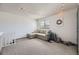 Bonus room with couch, carpet, and playful string lights at 3010 W Prentice Ave # J, Littleton, CO 80123