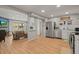 Open-concept kitchen with stainless steel appliances flows into a cozy living area with a large slider at 12112 Melody Dr # 302, Denver, CO 80234