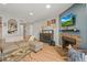 Comfortable living room with a fireplace, connected to the kitchen through a stylish arched partition at 12112 Melody Dr # 302, Denver, CO 80234
