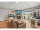 Cozy living room features a decorative fireplace, sliding glass doors, and a convenient workspace at 12112 Melody Dr # 302, Denver, CO 80234
