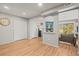 Bright living room with wood-look floors, closet, and a peek through to the living area with sliding glass doors at 12112 Melody Dr # 302, Denver, CO 80234