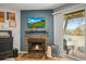 Charming living room with a fireplace, decor and sliding glass doors with outdoor view and natural light at 12112 Melody Dr # 302, Denver, CO 80234