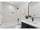 White bathroom with a bathtub and shower, modern vanity and minimalist decor at 1250 Yates St, Denver, CO 80204