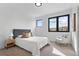Inviting bedroom boasts natural light, carpet flooring, and modern decor at 1250 Yates St, Denver, CO 80204
