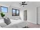 Cozy bedroom with modern windows, plush carpet and an elegant black ceiling fan at 1250 Yates St, Denver, CO 80204