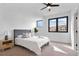 Bright bedroom with plush carpet, a comfortable bed, and modern ceiling fan at 1250 Yates St, Denver, CO 80204