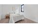 Bright bedroom features a comfortable bed, modern decor, and a light-filled window at 1250 Yates St, Denver, CO 80204