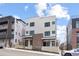 Modern townhouse with brick accents, dark framed windows, and shared front porches at 1250 Yates St, Denver, CO 80219