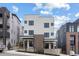 Modern two-story duplex featuring a white exterior with dark window frames and a brick accent on the facade at 1250 Yates St, Denver, CO 80204
