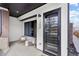 Stylish front porch featuring a black trimmed glass door and seating area, offering a welcoming entrance at 1250 Yates St, Denver, CO 80204