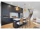 Modern kitchen featuring dark cabinetry, quartz countertops, stainless steel appliances and pendant lighting at 1250 Yates St, Denver, CO 80204