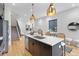 Open kitchen with island, stainless steel appliances, and bar stools, seamlessly integrated with the living area at 1250 Yates St, Denver, CO 80204