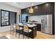 Contemporary kitchen with stainless steel appliances, dark cabinets, and quartz countertops, designed for culinary enthusiasts at 1250 Yates St, Denver, CO 80204