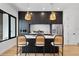 Modern kitchen featuring dark cabinetry, quartz countertops, and bar seating, ideal for entertaining guests at 1250 Yates St, Denver, CO 80204