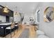Open-concept living space with kitchen island, hardwood floors, and stylish decor, perfect for modern living at 1250 Yates St, Denver, CO 80204
