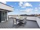 Rooftop deck with dining set, offering panoramic city views at 1250 Yates St, Denver, CO 80204