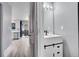 Modern bathroom with white vanity, black fixtures, and a large mirror at 3071 W 107Th Pl # C, Westminster, CO 80031