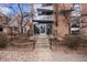 Building entrance framed by minimalist landscaping and featuring large glass entry doors at 1032 N Clarkson St # 201, Denver, CO 80218