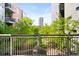 View from balcony features garden area and a distant building at 1401 Delgany St # 211, Denver, CO 80202