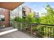 Balcony overlooking courtyard trees, building details, and blue skies at 1401 Delgany St # 211, Denver, CO 80202