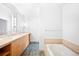 Bathroom with double sinks, tub and tile flooring at 1401 Delgany St # 211, Denver, CO 80202