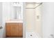 Bright bathroom featuring a walk-in shower with white tile and updated vanity at 1401 Delgany St # 211, Denver, CO 80202