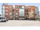 Contemporary brick apartment building with large windows, balconies, and modern architectural details at 1401 Delgany St # 211, Denver, CO 80202