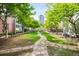 Beautifully landscaped garden path leading through lush greenery and trees at 1401 Delgany St # 211, Denver, CO 80202