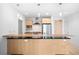 Bright kitchen features stainless steel appliances, light wood cabinetry, and a peninsula with bar seating at 1401 Delgany St # 211, Denver, CO 80202