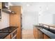 Stylish kitchen featuring stainless steel appliances, wood cabinetry, and ample counter space at 1401 Delgany St # 211, Denver, CO 80202