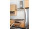 Up close view of kitchen with stainless steel appliances, tile backsplash and light wood cabinets at 1401 Delgany St # 211, Denver, CO 80202